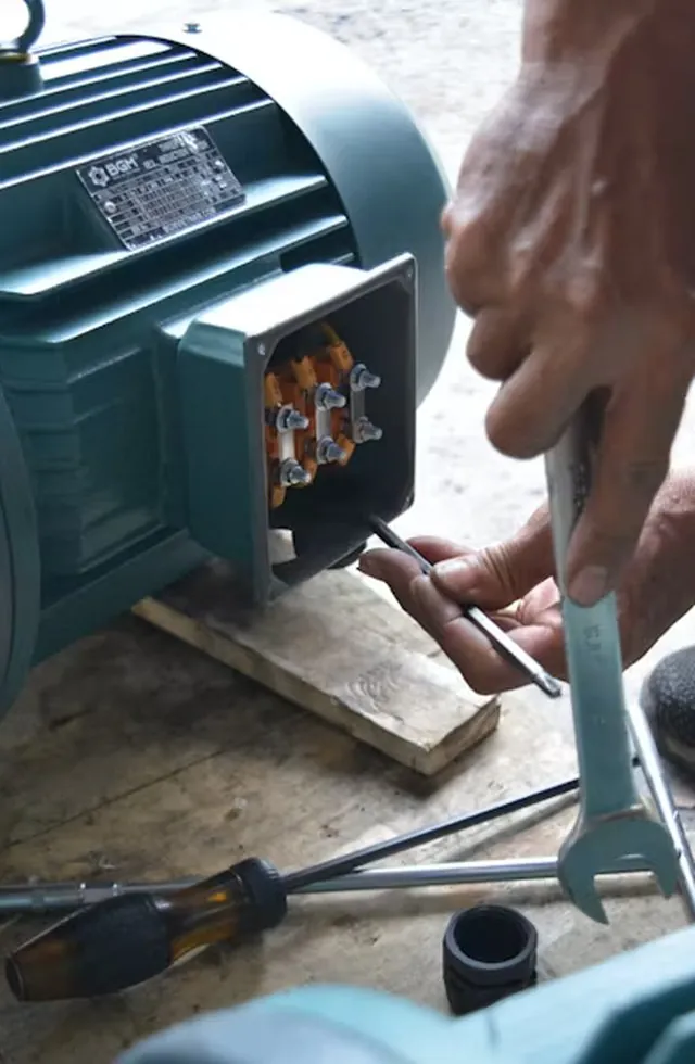 Technician working on the terminal box of an electric motor